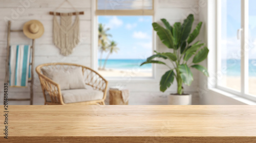 Wooden tabletop surface background with blurred tropical beach house interior for product display mockup