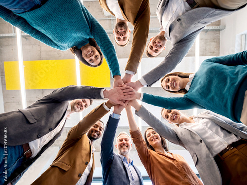 Business team teamwork group unity stack hand smiling office diverse business team smiling with hand stack office
