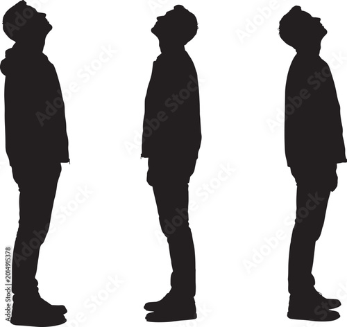 Silhouettes of three men standing and looking up 