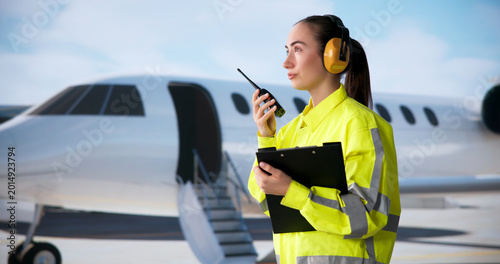 Fotografia Airport Ground Crew Woman Holding Tablet Talks