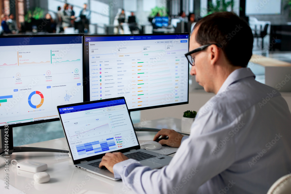 Naklejka premium Sales Manager Studies Customer Data On Laptop
