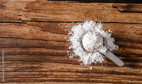 Photos Sports supplements on a wood table background with copy space