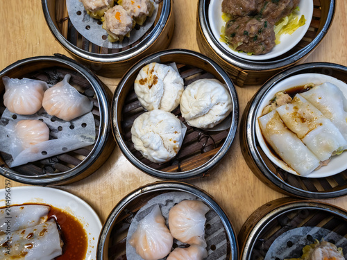 Canvas Print Halal dim sum assortment in bamboo steamers on wooden table