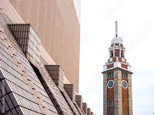 Photography Historic clock tower beside modern geometric architecture in Hong Kong
