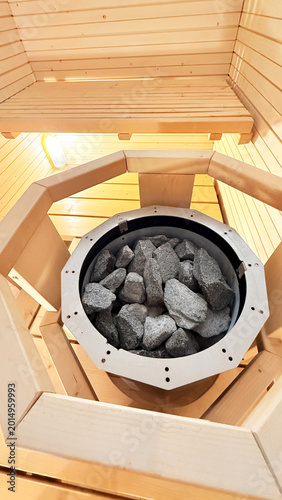Finnish Sauna Stove with Natural Heating Stones in Wooden Spa Room