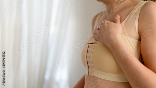 Bild auf Leinwand A woman shows emotional distress during difficult recovery after breast reconstruction