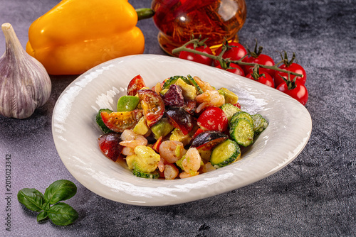 Obraz na płótnie Gourmet shrimp and avocado salad with cherry tomatoes, cucumber and fresh vegeta
