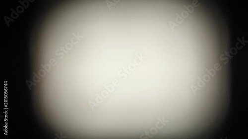 Faded and blurry abstract black background texture with grey, white, chrome or silver color center for copy space. Retro vintage style 80s or 90s vibe graphic design background with shaky motion.