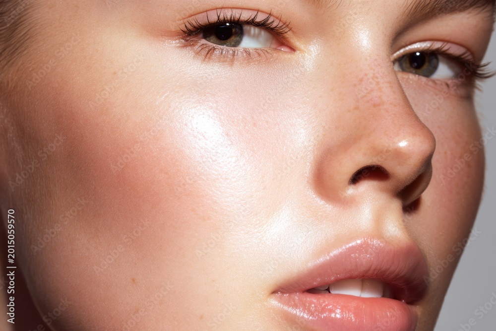 Fototapeta premium Close-up of glowing skin with freckles showing effective skincare routine