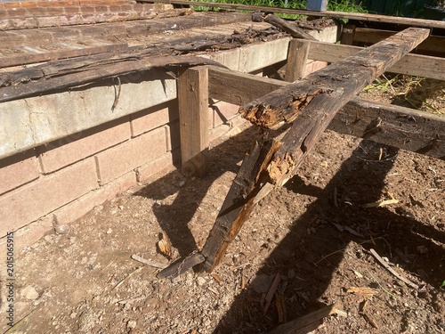 Rotted wood deck boards decayed timber caused by fungi thriving in damp conditions, represent a significant structural risk, house renovations project.
