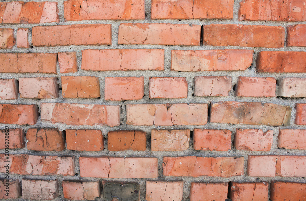 Fototapeta premium Weathered brick masonry wall close up