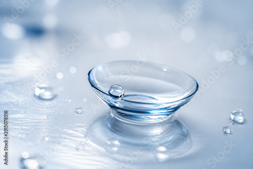 Transparent Contact Lens in Glass Dish with Water Drops Clean Vision Care Concept