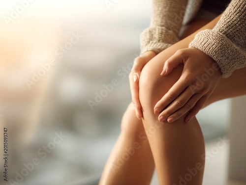 Close Up of Woman Holding Painful Knee at Home Joint Pain and Mobility Problem Concept