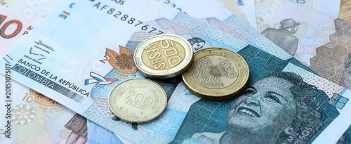 Colombian peso money bills and coins on table. Colombia cash of COP currency close up