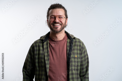Portrait, smile and man with casual outfit, funny and model isolated on a grey background.