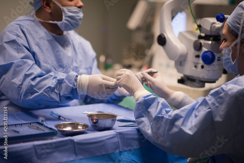 Tableau sur toile Eye surgery team performing microsurgery in a modern Middle Eastern eye hospital