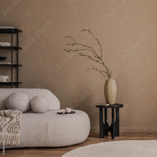 Fotografie Minimalist beige interior with modern furniture, a ceramic vase on a black table, and a soft round rug, styled with natural textures and warm neutral tones