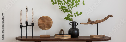 Foto Stylish and minimalist composition on wooden design commode with copy space, flowers in vase, decorations and personal accessories