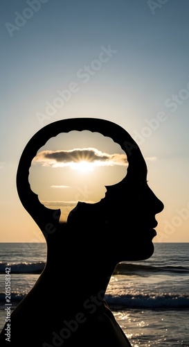 Silhouette of a human head with a sunset in the brain area