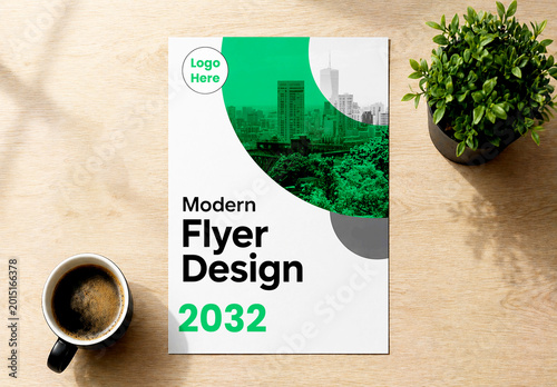 Modern Flyer Mockup on Wooden Desk with Coffee Cup and Plant in Bright Interior