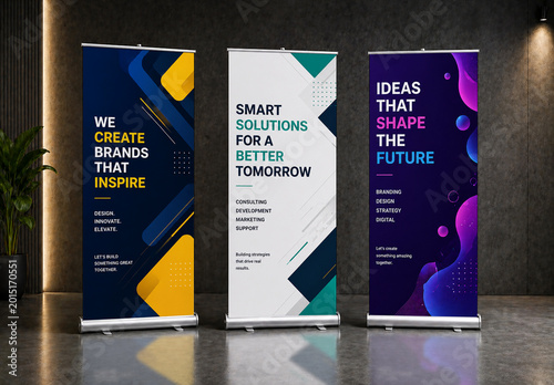 Three Vertical Roll-up Banner Mockups Standing in Modern Office Interior with Spotlight