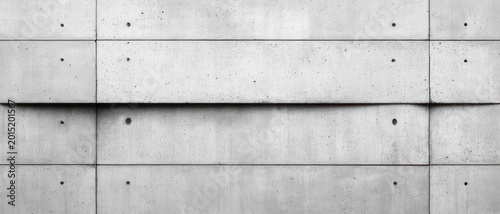 austere minimalist concrete wall with horizontal panel seams, circular tie holes and subtle shadows