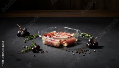 Elegant ham and cheese rollitos in moody lighting