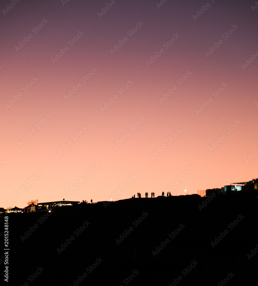Obraz premium Human silhouettes at sunset, human figures on the hill