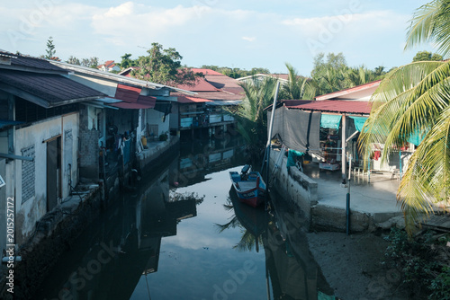 Tableau sur toile Quiet canal winds between modest houses