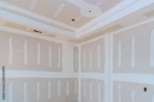 Freshly drywalled room ready for paint finishing touches in modern home renovation