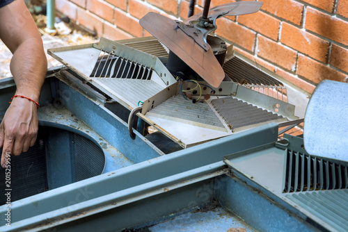 Repair work on an outdoor cooling unit in residential area