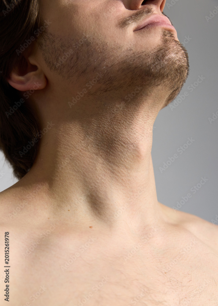 Fototapeta premium a close portrait of a man with stubble, without outerwear. Photography of body parts