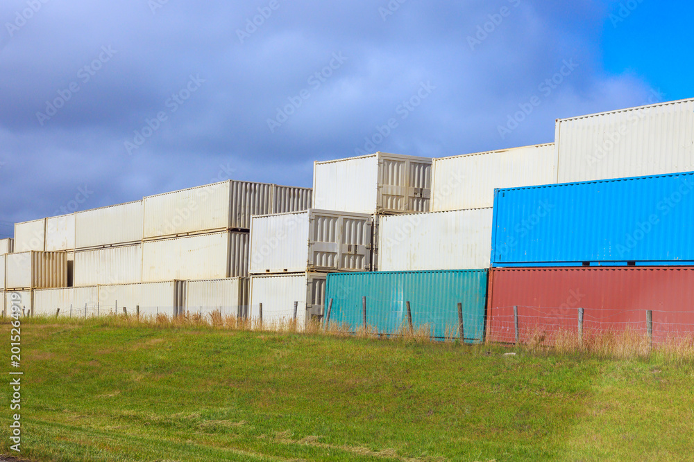 Fototapeta premium Shipping containers stacked at storage facility during logistics hub
