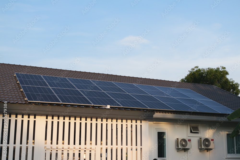 Fototapeta premium Solar energy installation residential roof urban setting photovoltaic panels clear sky