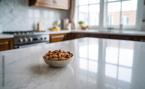 Healthy almond nuts in a small bowl on a white marble kitchen island