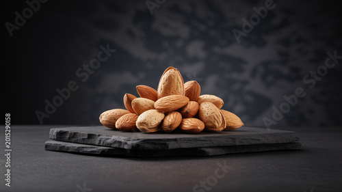 Premium Raw Almonds on Dark Slate Board with Moody Lighting and Copy Space