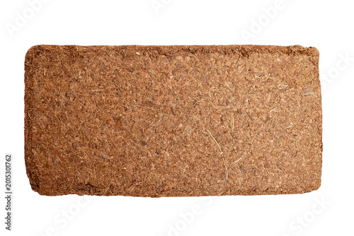 Compressed coconut coir brick for gardening, showcasing natural fibers and texture, ideal for soil amendment and plant growth in sustainable gardening practices