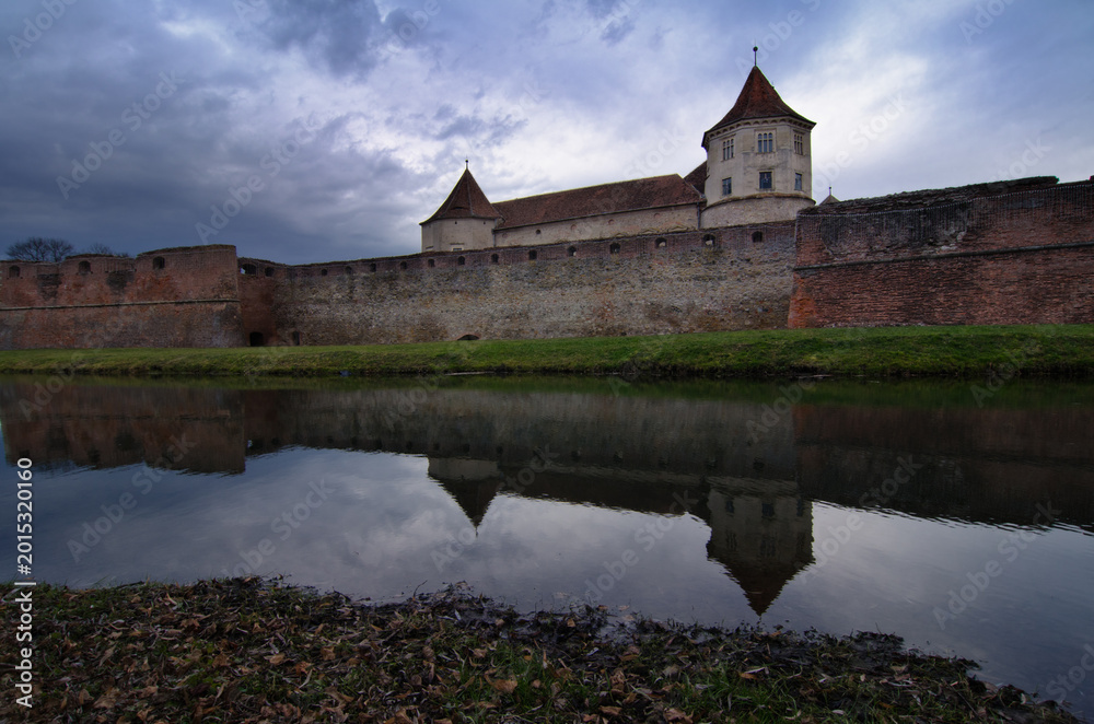 Fototapeta premium Reflection of medieval Fagaras Fortress in water moat