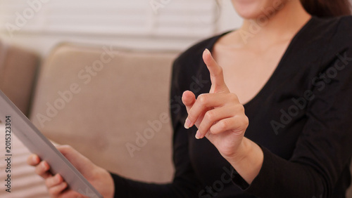 Cuadro en lienzo Asian women business professional hold tablet device point finger gesture explai