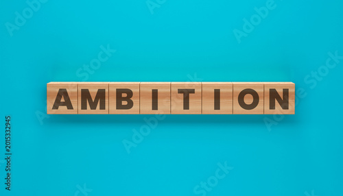 Tableau sur toile Ambition Word Blocks: A wooden block arrangement spells out the word AMBITION against a vibrant, solid-color backdrop, symbolizing drive and aspiration