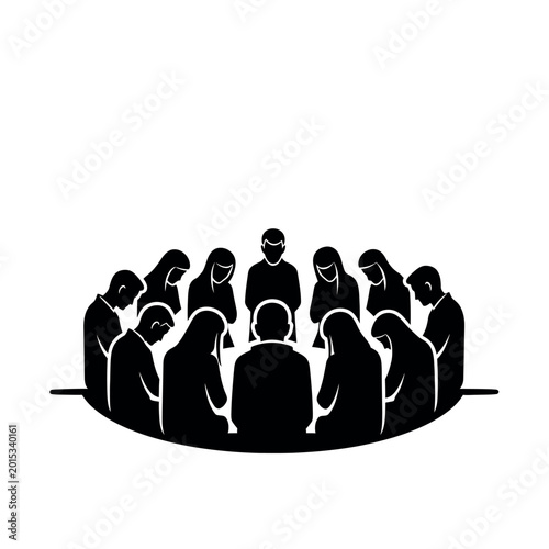 Group of people sitting in a circle heads bowed in prayer or meditation.