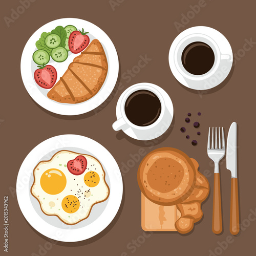 Top-down view of a delicious breakfast spread with coffee, eggs, croissant, and pancakes.