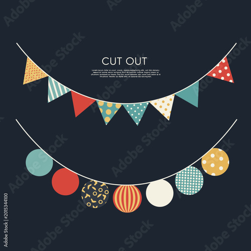 A collection of colorful festive bunting flags and circular decorations strung on a dark background.