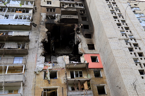 Russian missile strike destroyed house in Dnipro, Ukraine. A large hole in residential building after drone strike and a fire. Russia s war against Ukraine.