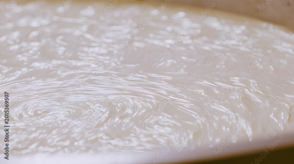 Obraz premium laminar. Industrial mixing tank rotating, stirring thick paste, close-up on viscous texture. safety posters, maintenance manuals, designed for industrial assembly lines and welding operations.
