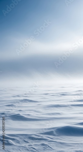 Heavy, swirling snow driven by strong winds creates extremely low visibility across a desolate, frozen winter landscape, icy, white, tempest