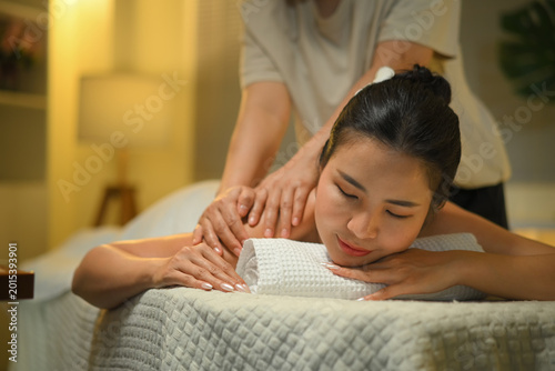 Fotografie Photo set of Woman receiving shoulder massage at spa with warm light and deep re