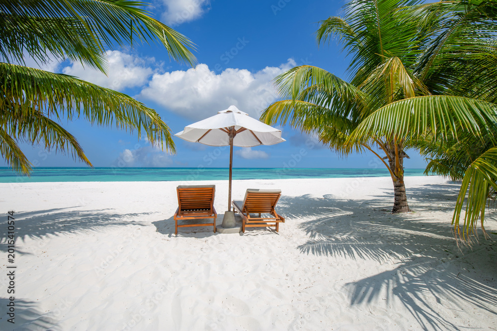 Fototapeta premium Beautiful panoramic ocean sand sky view with tropical relax beach sunny summer island landscape featuring love couple chairs umbrella and palm leaves on romantic coast for luxury travel getaway