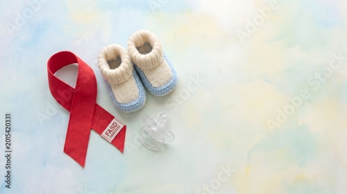 FASD Awareness Ribbon with Baby Shoes and Pacifier – Maternal Health Campaign Concept