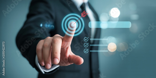 Businessman pointing to target with arrow for business success and goal achievement in strategy planning.